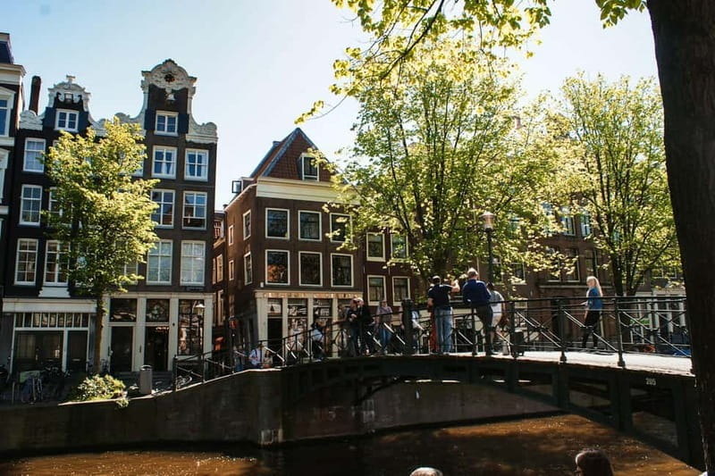 Amsterdam: Iconic Canals & Historic Sights Walking Tour - Canals, bridges, leaning houses, and secret churches