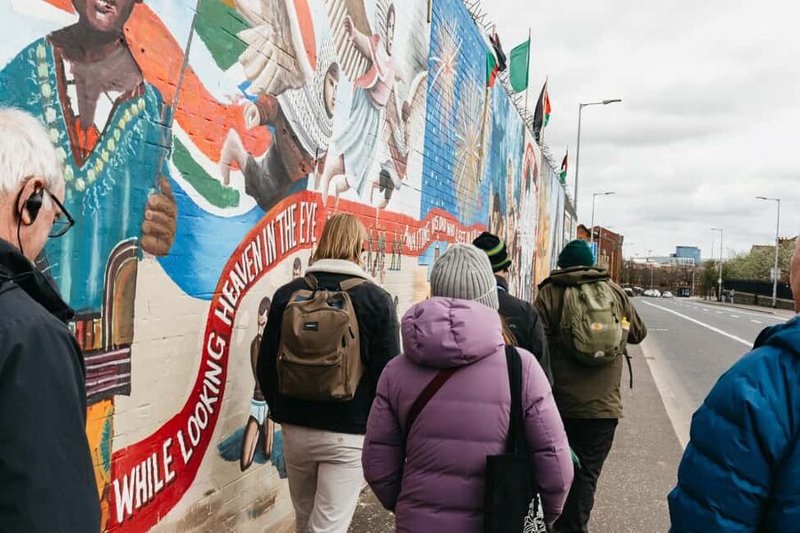 Belfast: The Troubles Walls & Bridges Guided Walking Tour - Walking toward Divis and the Falls area