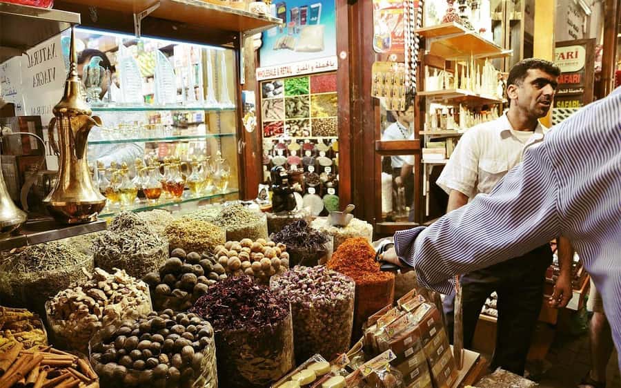Dubai: Old City Walking Tour with Abra Ride - Starting near Sharaf DG and walking into Al Seef