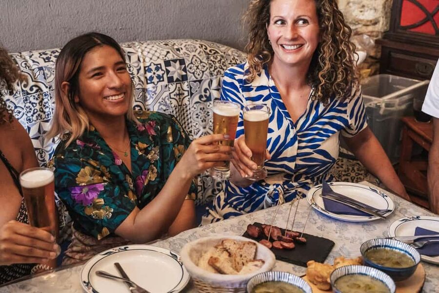 Lisbon: Food & Wine Walking Tour Through Baixa - Meeting your guide beneath the Portuguese flag